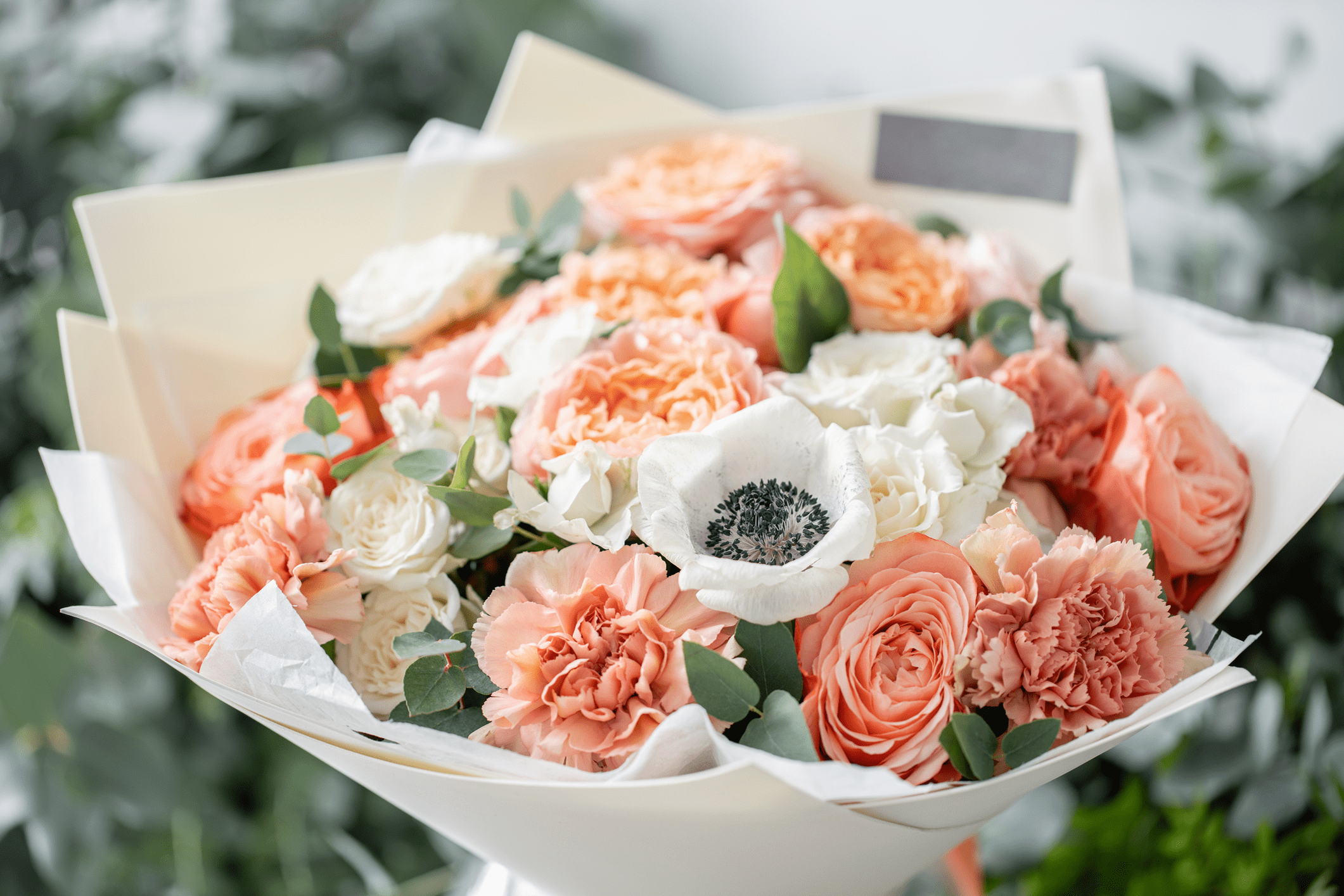 Bouquet of peach and white flowers.