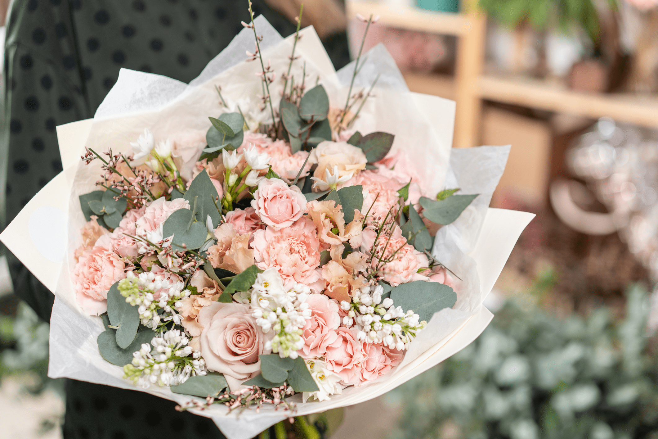 Bouquet of pink roses and eucalyptus leaves.
