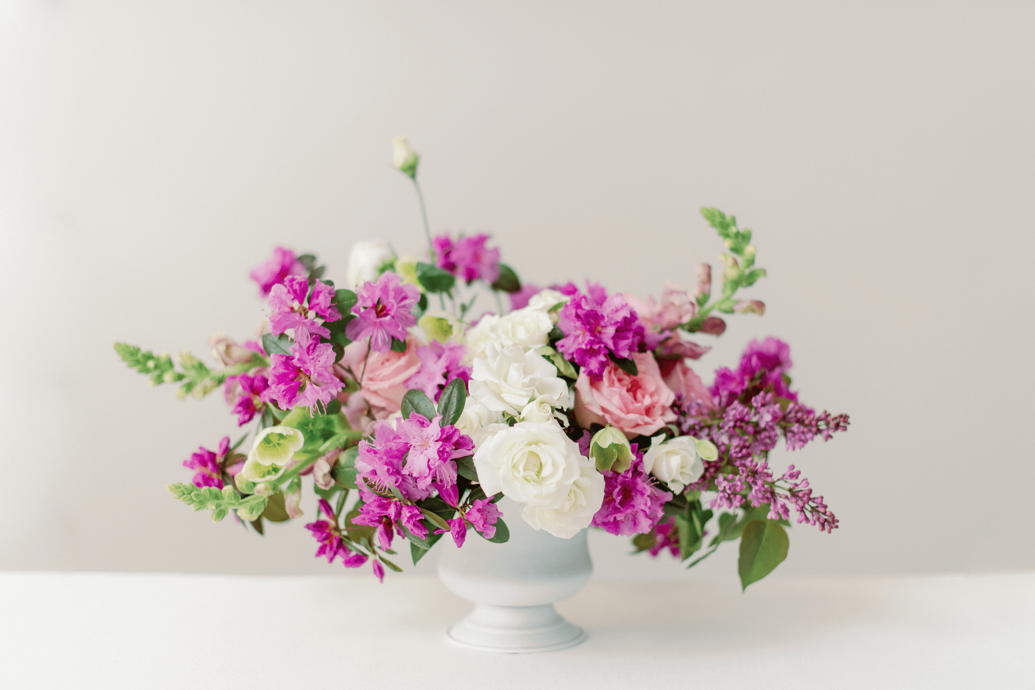 Elegant floral arrangement in a white vase.